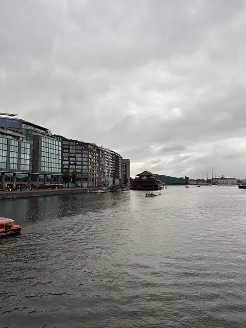 Modern waterfront buildings beneath a grey sky.