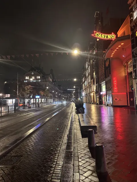 Lights reflected on a wet street outside a casino.