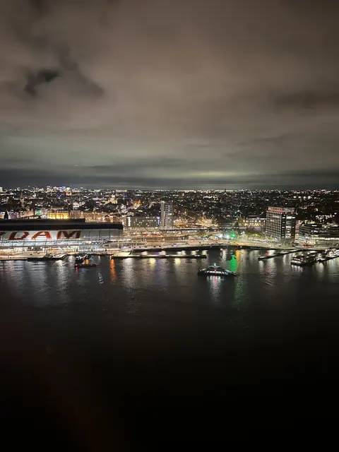 City lights reflected across the waterfront at night.