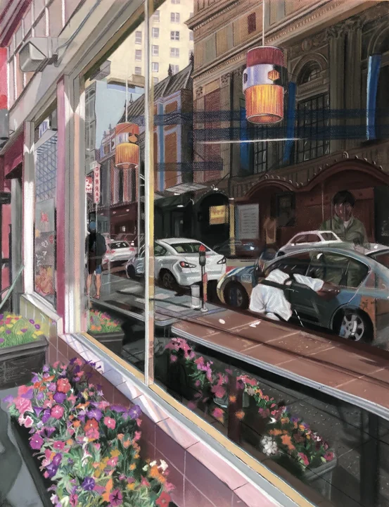 An urban storefront scene with reflections, passing cars, and flowers.