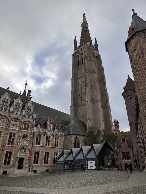 A tall stone bell tower rising above a town square.