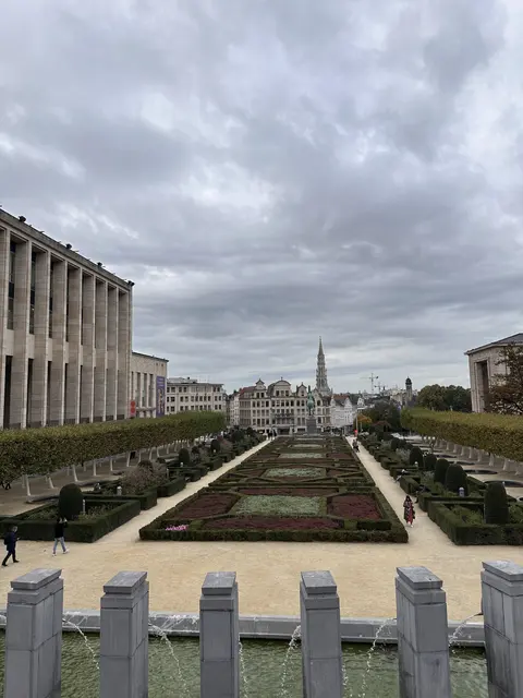 A formal terraced garden with the city skyline beyond.