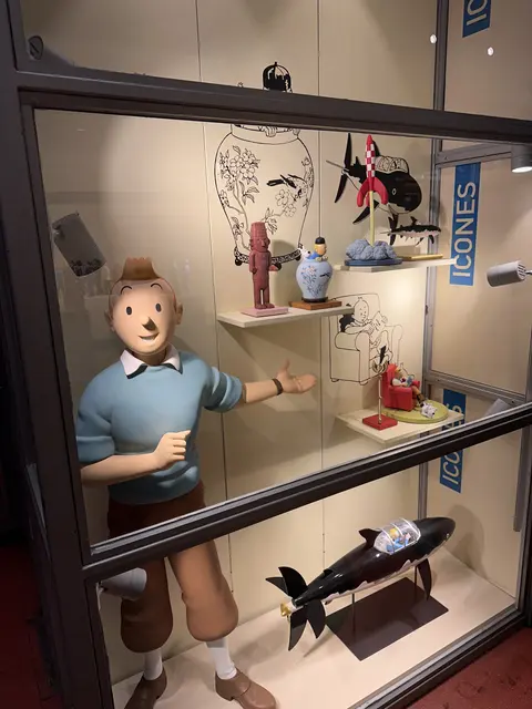 A display cabinet containing a comic character figure and memorabilia.