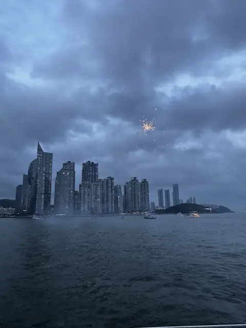A waterfront skyline beneath a blue evening sky.