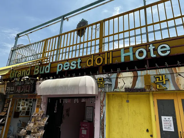 A brightly painted storefront on a hillside street.
