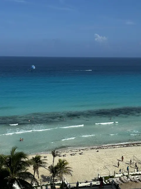 Turquoise sea and a sandy beach seen from above.