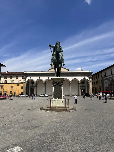 An equestrian statue in an open piazza.