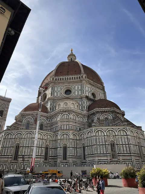 A richly patterned cathedral facade beneath a large dome.