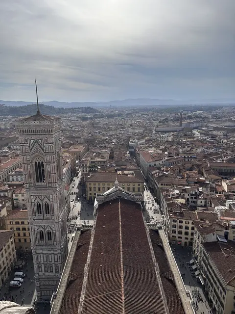 A bell tower and cathedral roof above the city.