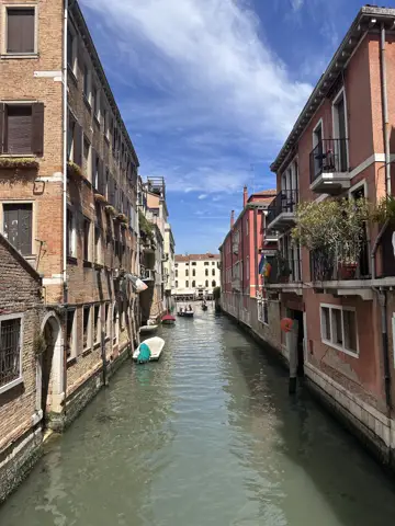 A narrow canal between buildings in Venice.