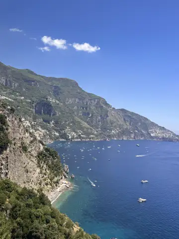 A winding coastline and mountains above the sea.