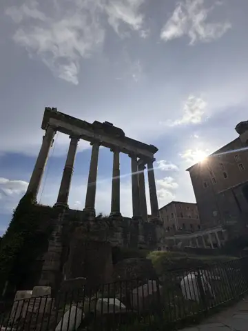 Sunlight breaking through ancient stone columns.
