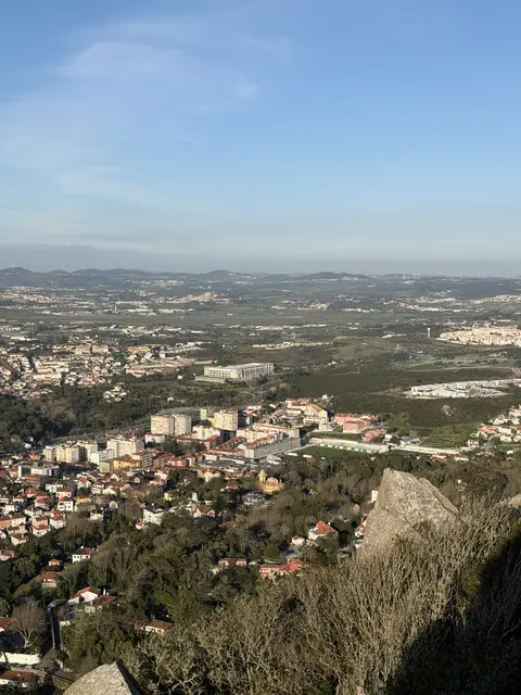 A broad view over a town and green countryside.
