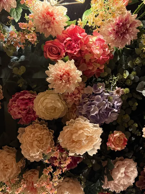 A colorful arrangement of roses and other flowers.
