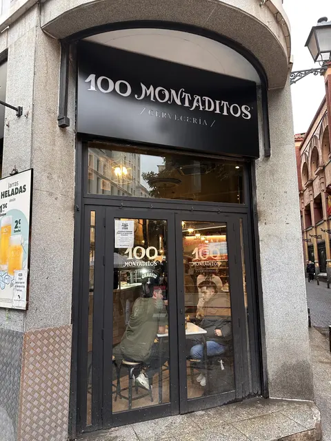 A restaurant entrance on a narrow city street.