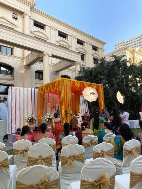 Guests seated at an outdoor celebration with colorful decorations.