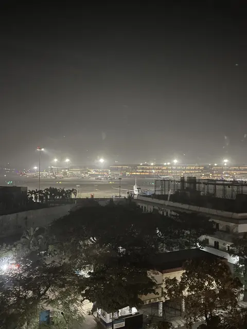 Distant city lights glowing through haze at night.