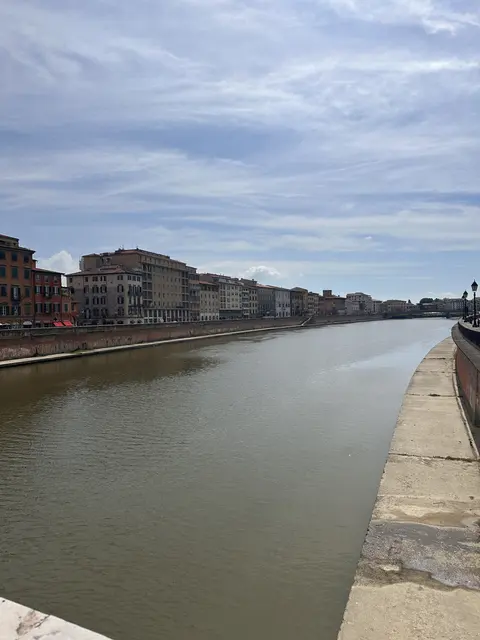 A river bordered by historic city buildings.