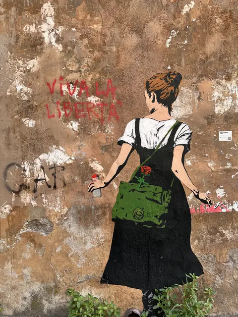 A painted figure on a weathered wall.