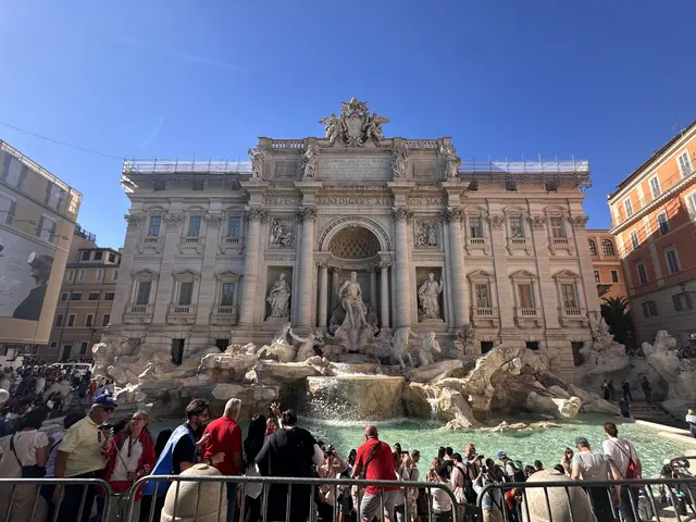 Crowds gathered in front of an ornate fountain.