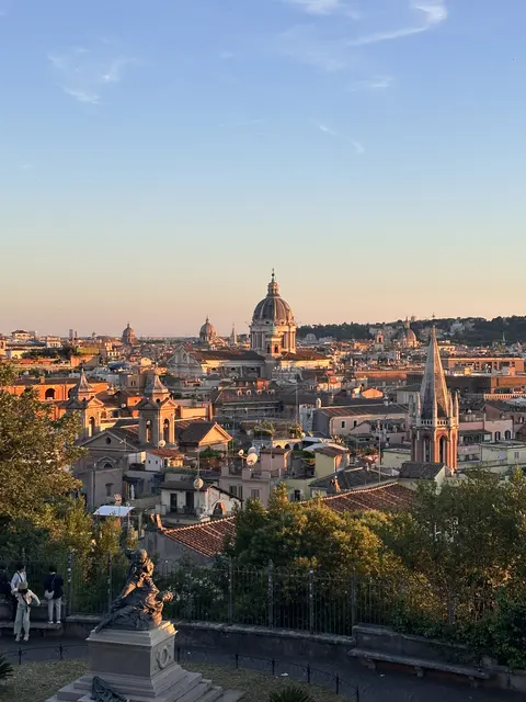 Warm evening light over city rooftops and domes.
