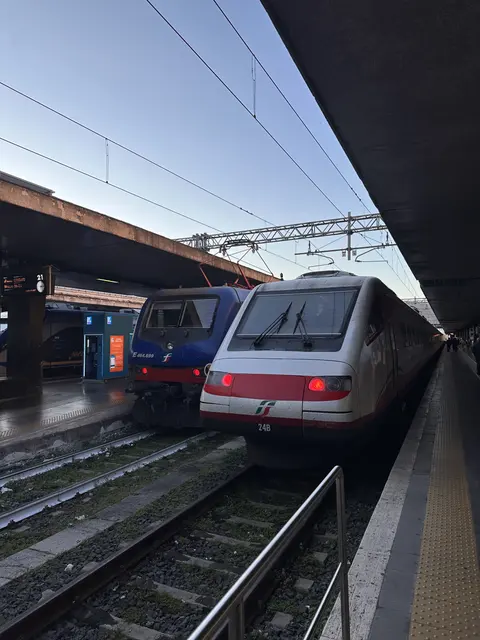 Trains beside a railway platform.