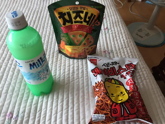 A soft drink, instant noodles, and a packaged snack.