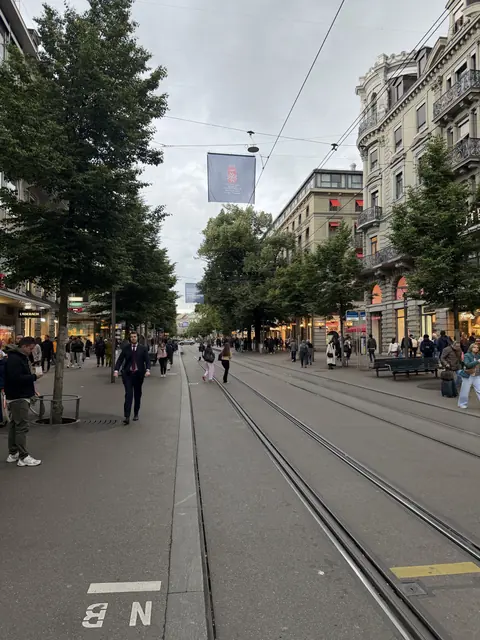 Trams and pedestrians share a shopping street in Zürich.
